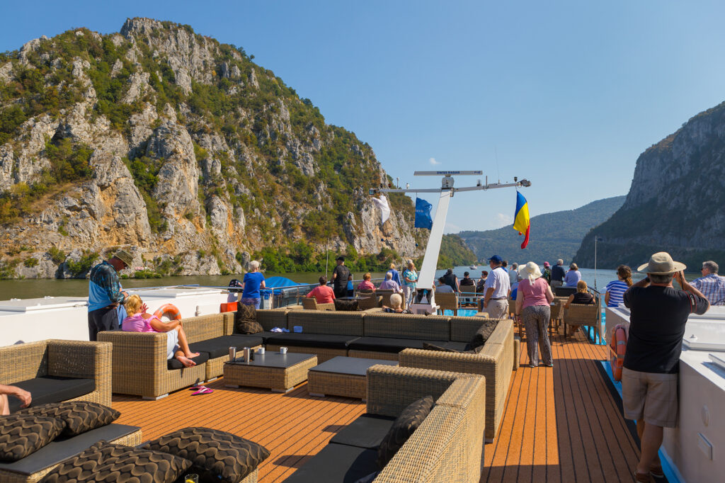 Travelers enjoying scenic views from the deck of a European river cruise ship
