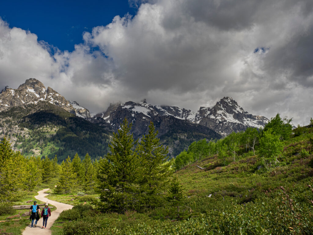 Couple hikes on Bradley Taggart Trail, Grand Teton National Park, Wyoming. Romantic getaway. Allegro Luxury Vacations. Brenda Ajay, Virtuoso luxury travel advisor