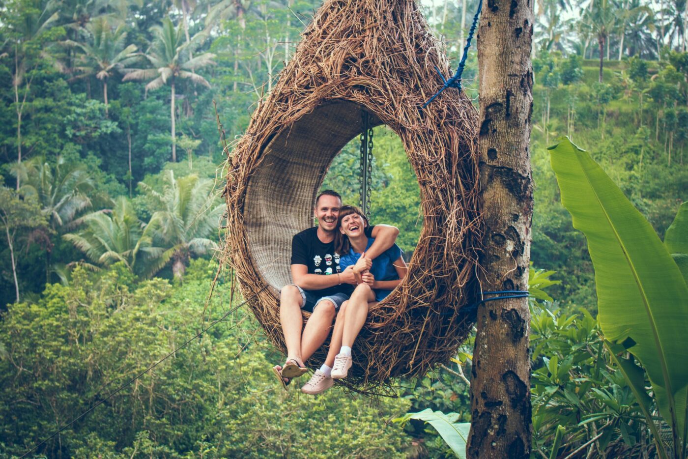 Honeymoon couple on a swing in the jungle in Bali. Honeymoon travel advice, Allegro Luxury Vacations, Brenda Ajay